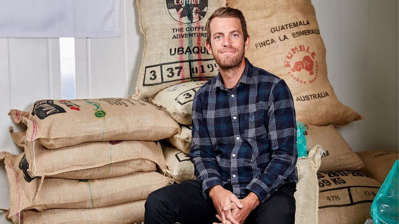 Man sitting in coffee bean sacks 