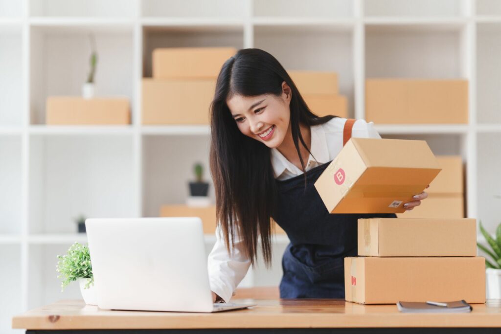 girl with boxes illustrating the best places to sell online