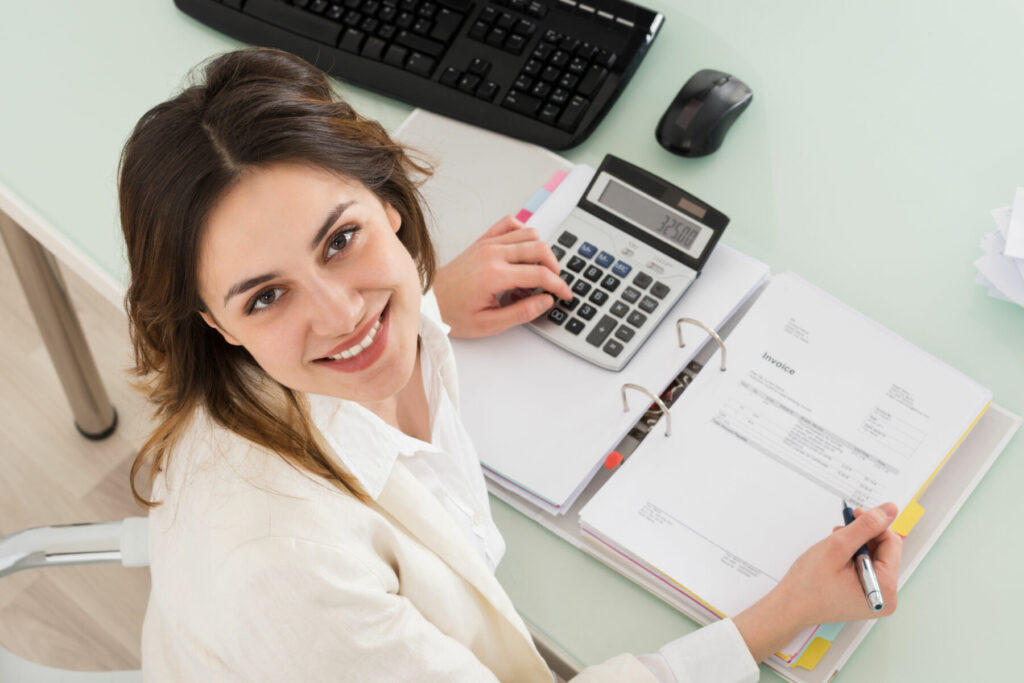 Woman looking up while doing calculations